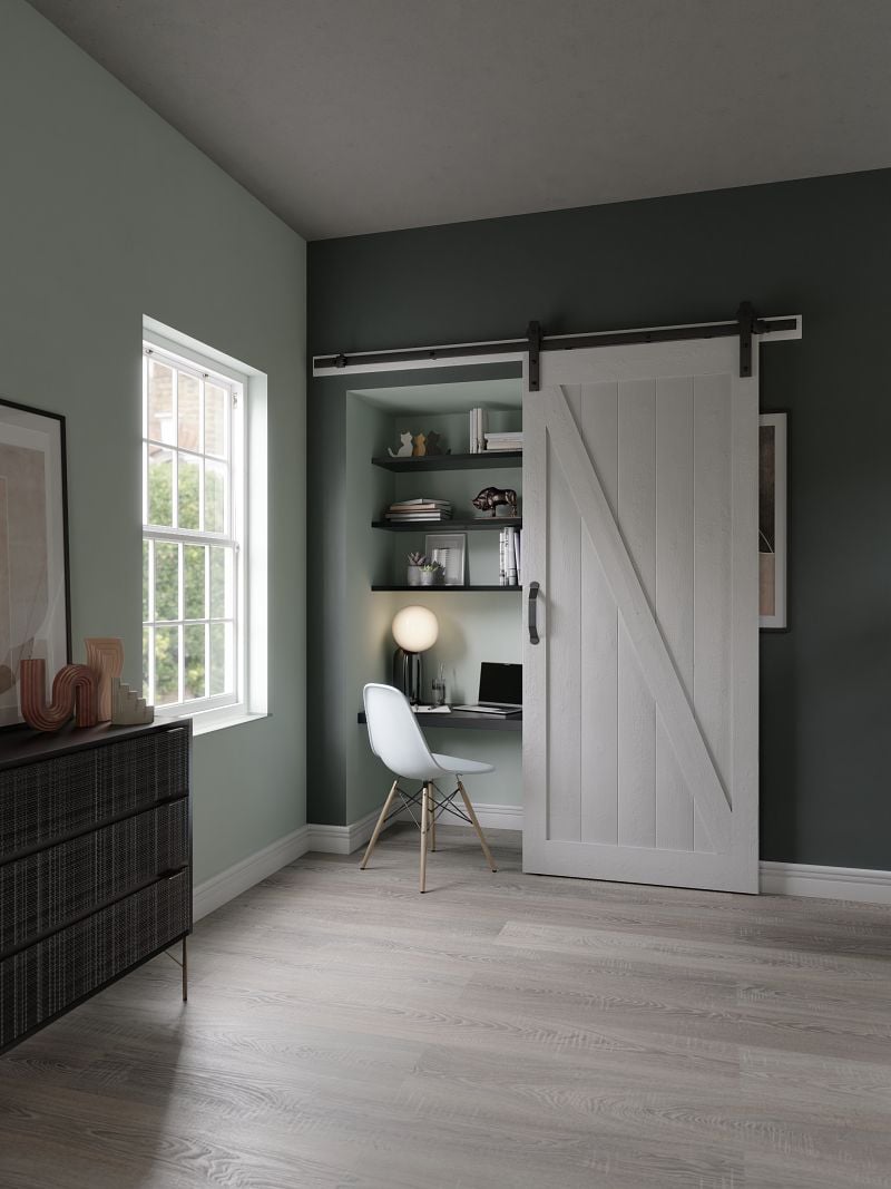 a gray barn door being used for a closet office